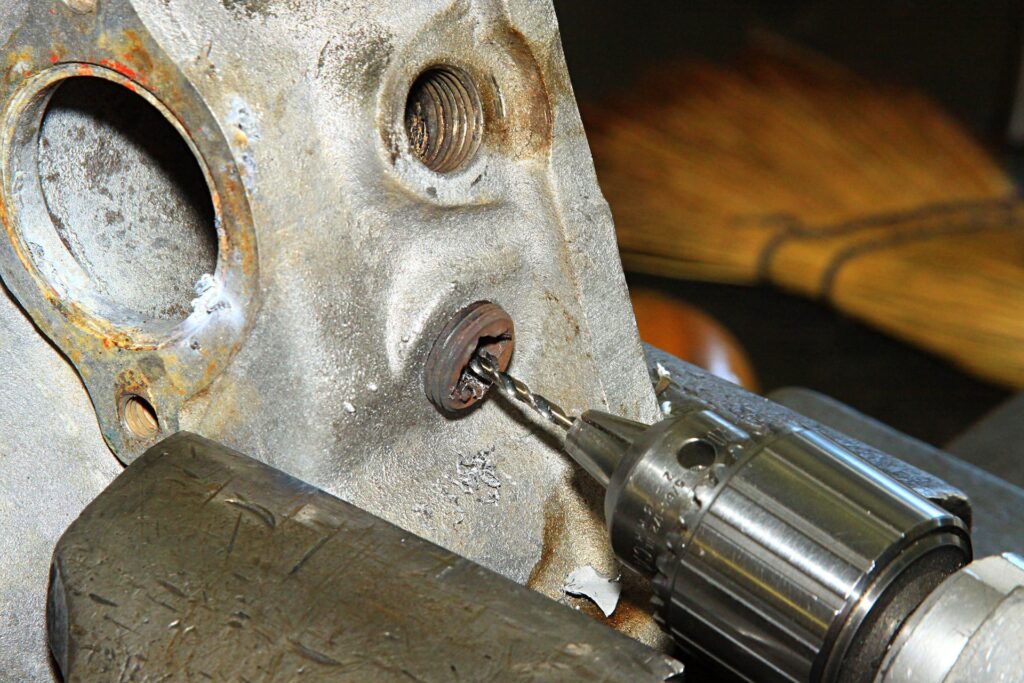 How can you remove rusted bolts effectively by following a patient and strategic approach